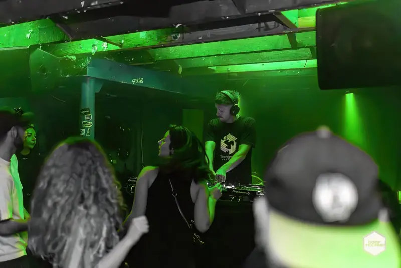 The crowd presses up close to the booth. Launch night, May 2025