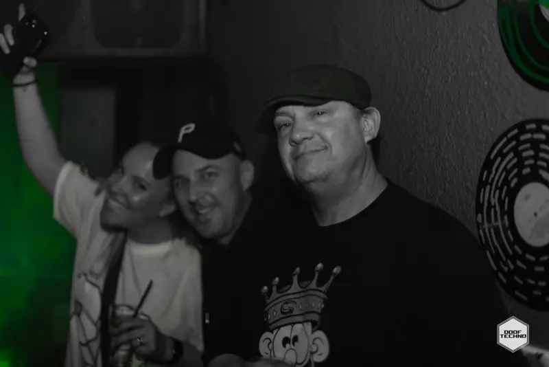 Three mates crowd in for the camera, one arm up