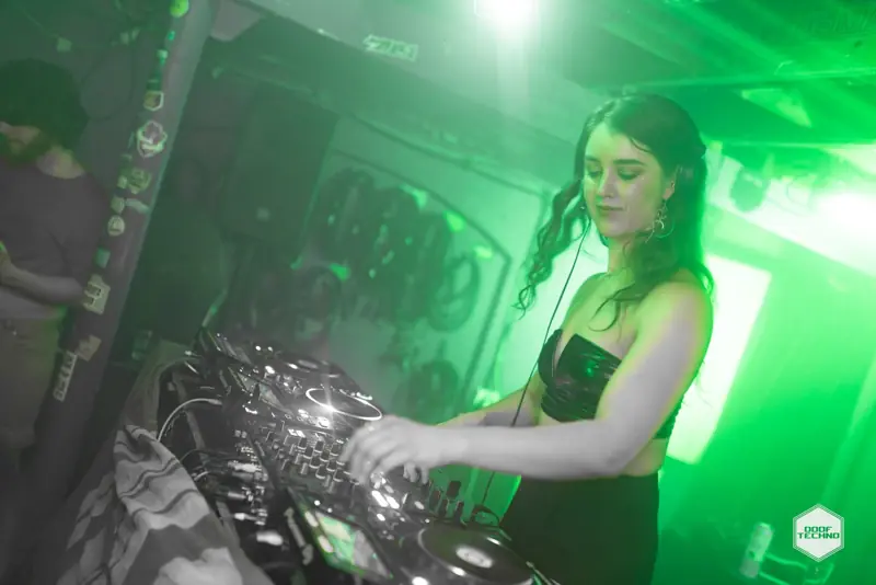 A DJ smiles down at the mixer