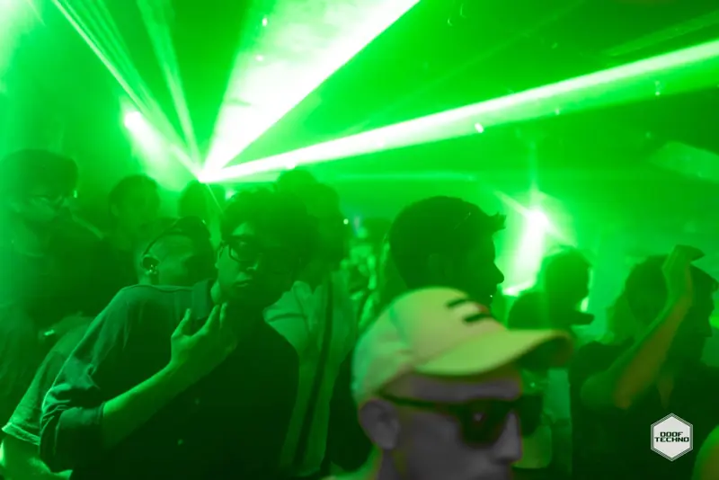Laser beams cut across the dancers