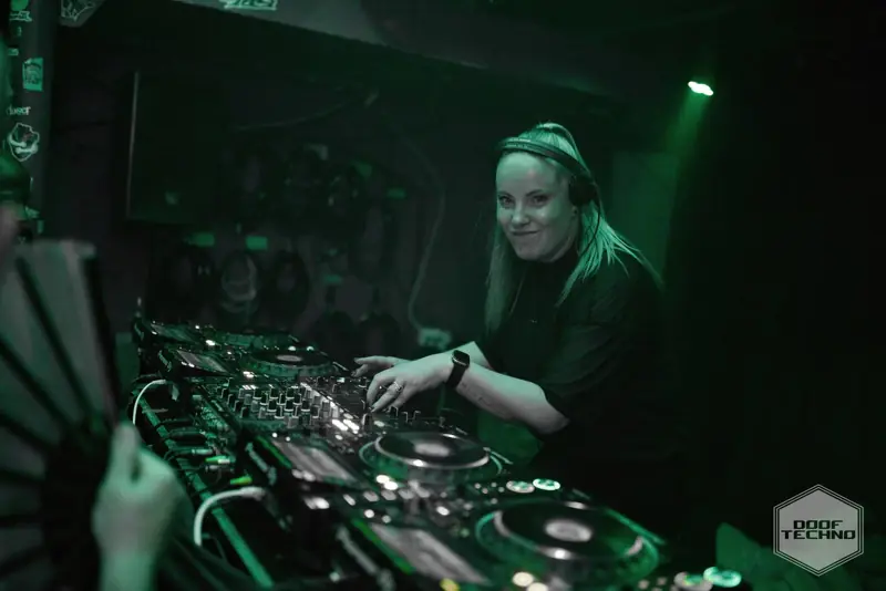 A DJ smiles mid-mix