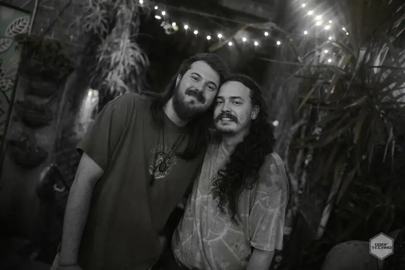 Two long-haired mates by the greenery