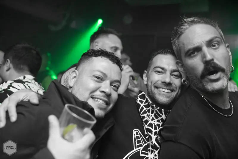 Three mates cheek to cheek, mid-laugh. Kaufmann at Electric Circus, Oct 2026